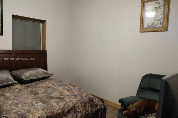 a bedroom with a bed and a chair