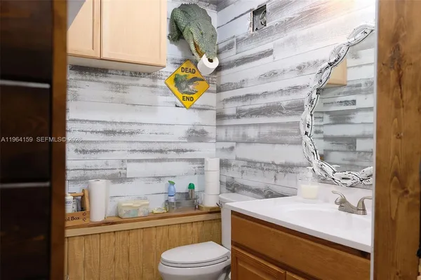 a bathroom with a sink mirror vanity and toilet