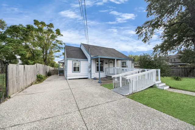 a view of a house with a yard and sitting area