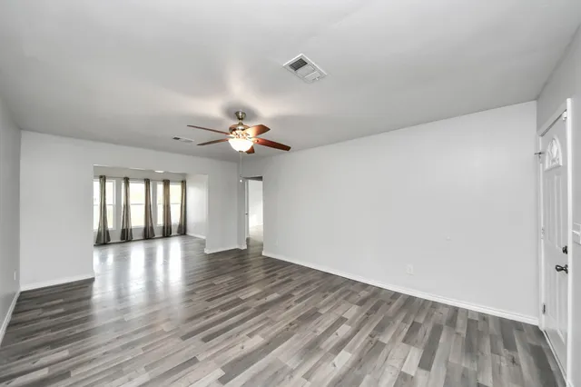 wooden floor in an empty room with a window