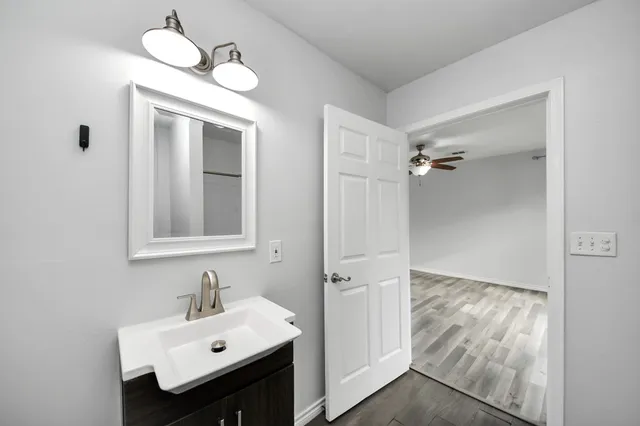 a bathroom with a sink mirror and vanity
