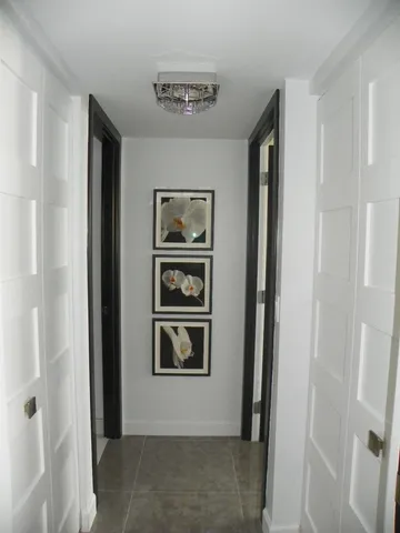 a view of a hallway with cabinets