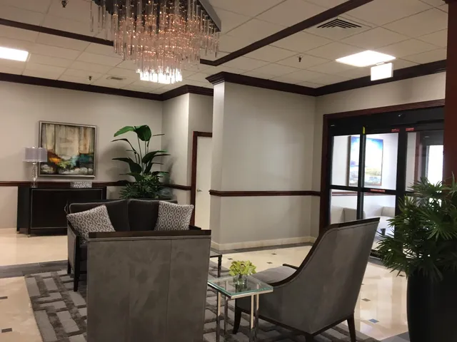 a dining room with furniture and chandelier