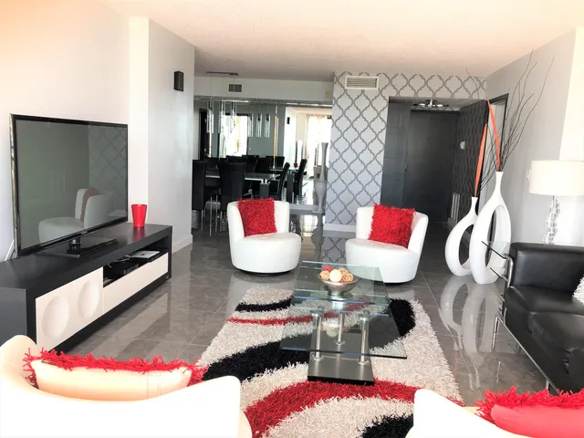 a living room with furniture rug and white walls
