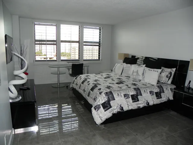 a bedroom with a bed chair and a window