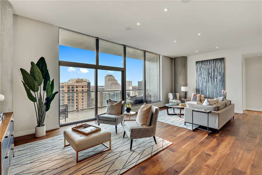 a living room with fireplace furniture and a floor to ceiling window