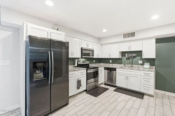 a kitchen with a stove oven and sink