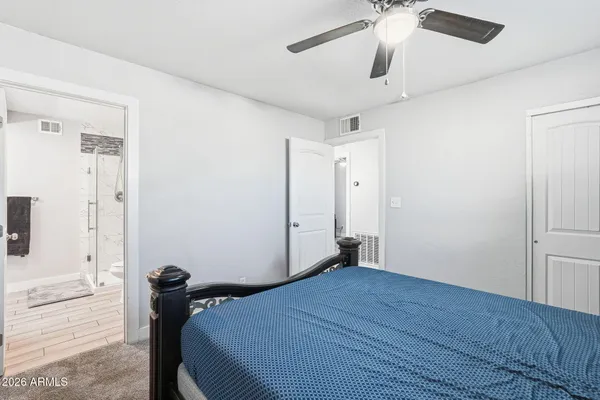 a bedroom with a bed and a chandelier