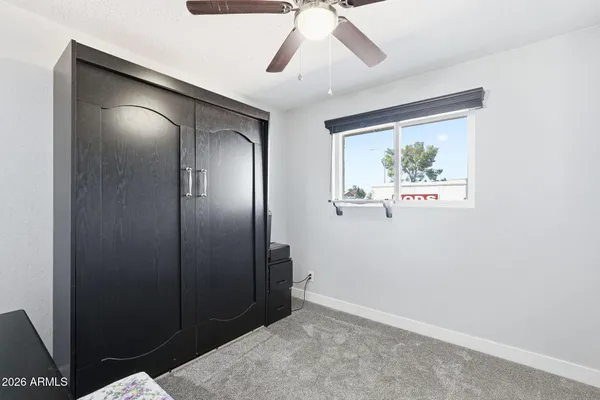 a bathroom with a granite countertop sink a toilet and a mirror