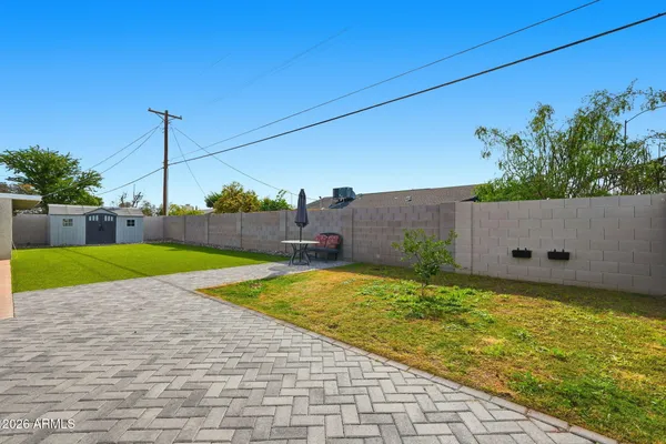 a view of a backyard with wooden fence