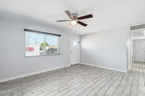 a view of a living room a refrigerator and a fireplace