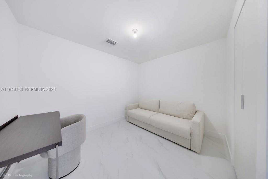 700 Northeast 24th Street, Unit 1403 Miami, FL 33137 - Photo 12 of 16 a living room with furniture and a couch