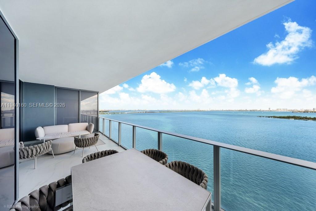 700 Northeast 24th Street, Unit 1403 Miami, FL 33137 - Photo 6 of 16 a bedroom with furniture and wooden floor