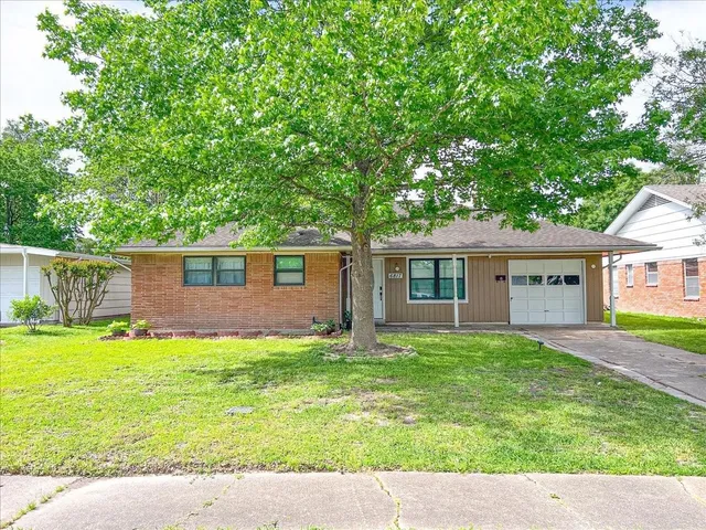 a backyard of a house with yard and outdoor seating