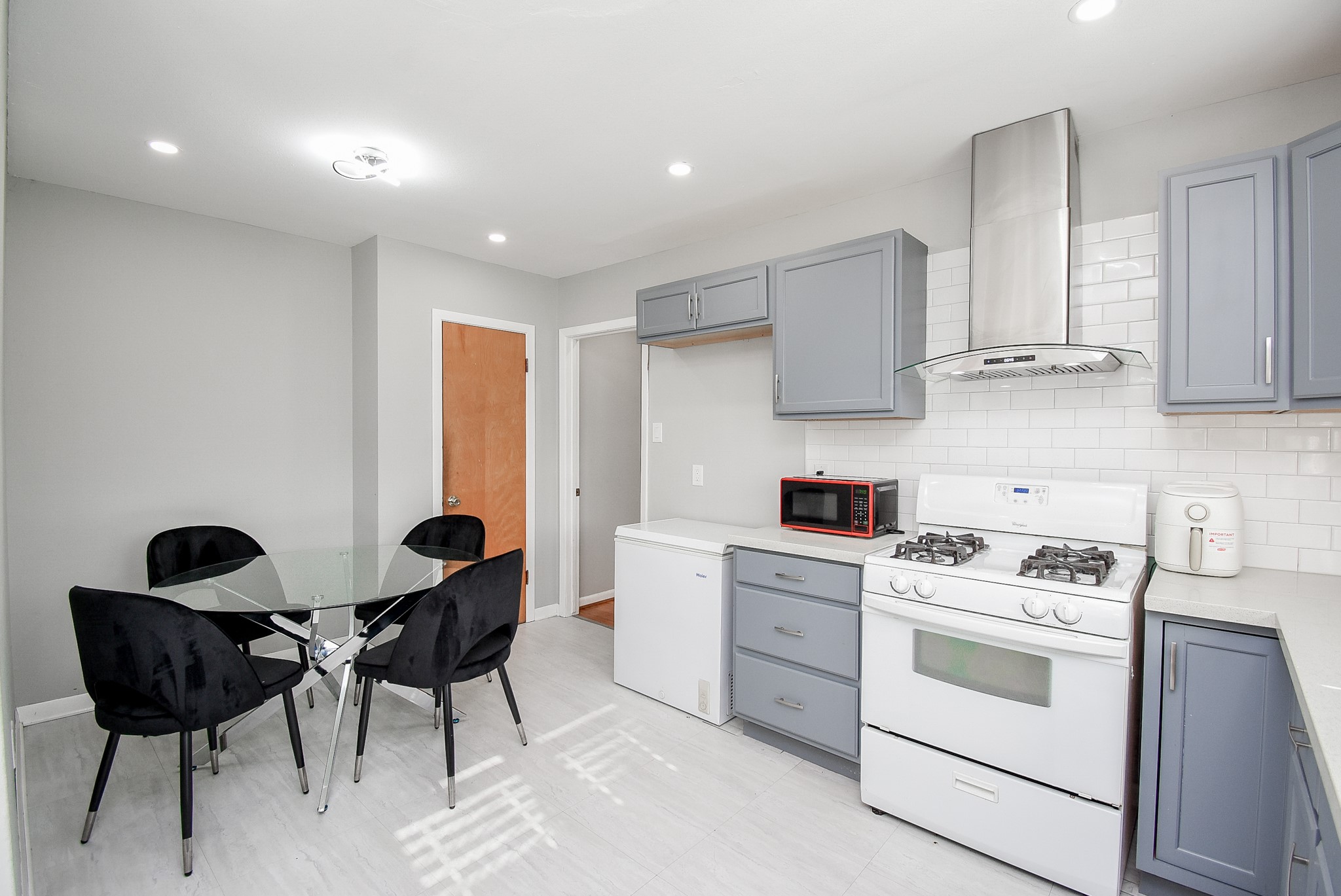 6817 Hendon Lane Houston, TX 77074 - Photo 13 of 30 a kitchen with stainless steel appliances a stove a sink cabinets and a dining table