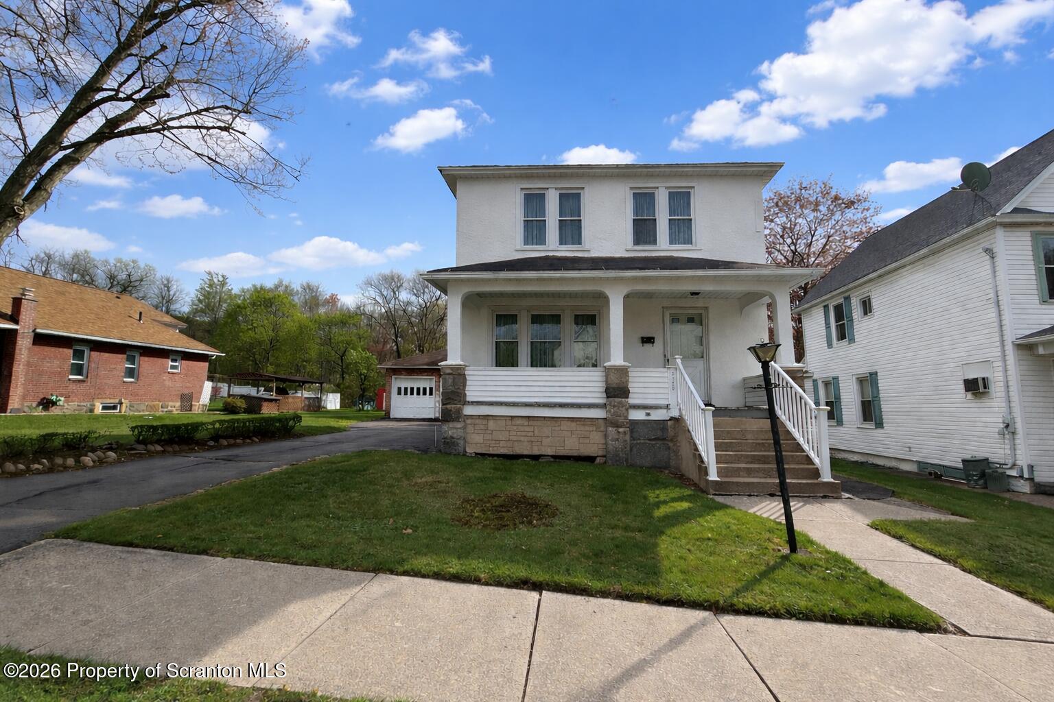 2120 Myrtle Street Scranton, PA 18510 - Photo 2 of 42 a front view of a house with a yard