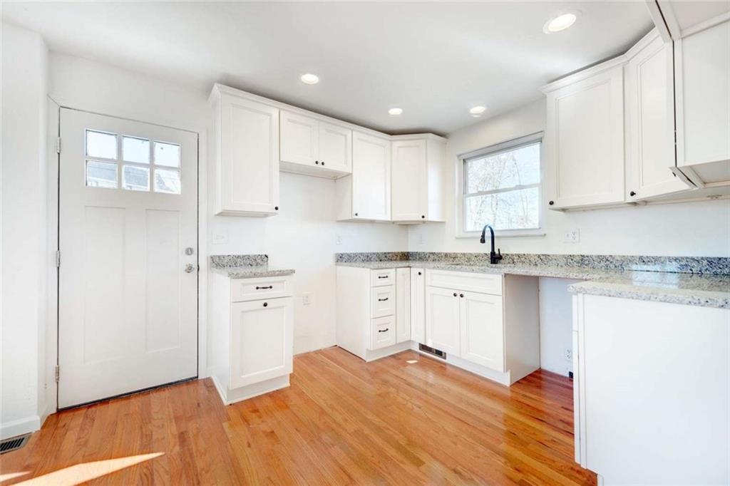 476 Peach Way Irwin, PA 15642 - Photo 20 of 25 a kitchen with granite countertop white cabinets and white appliances