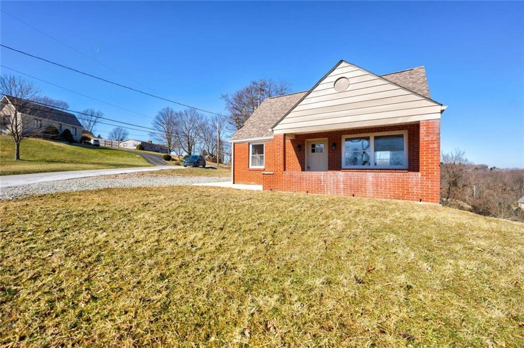 476 Peach Way Irwin, PA 15642 - Photo 3 of 25 a front view of a house with a yard and garage