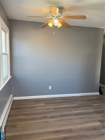 a view of a small space with wooden floor and a window