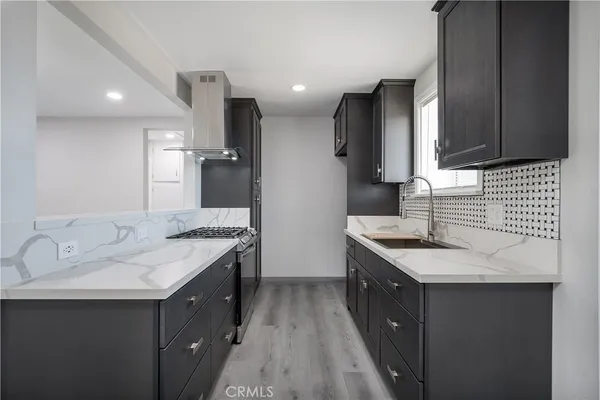 a kitchen with a sink stove and refrigerator