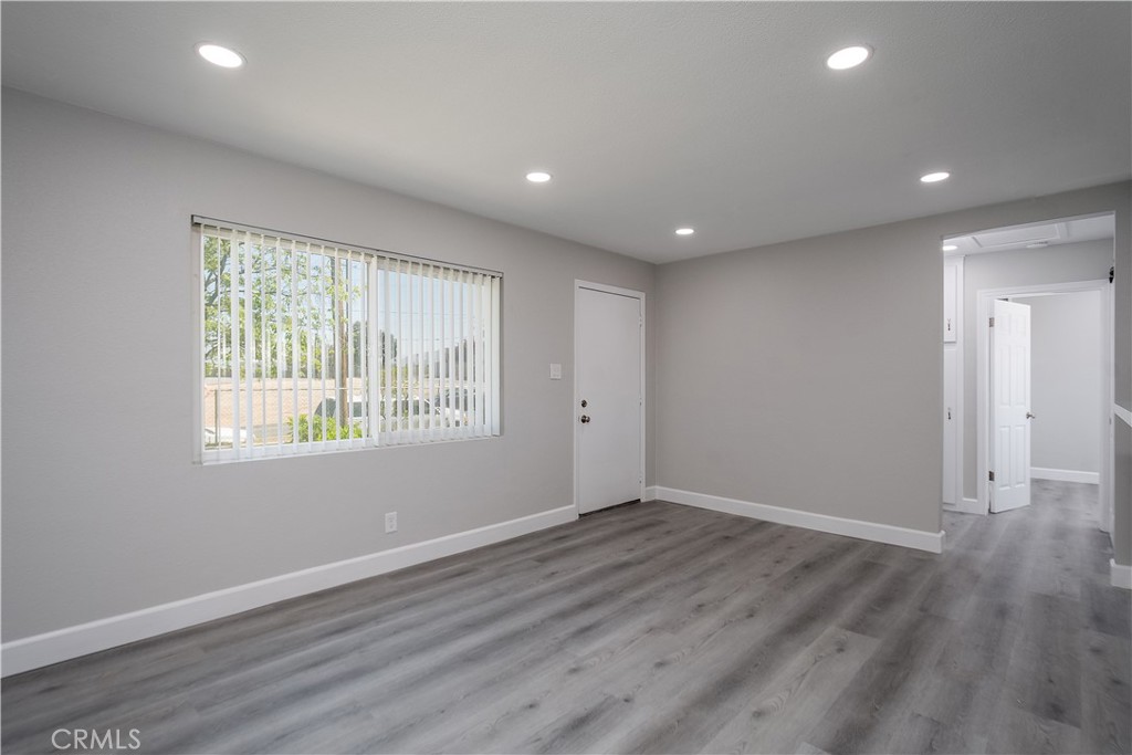 3630 Russell Street Riverside, CA 92501 - Photo 4 of 18 a view of an empty room with wooden floor and a window