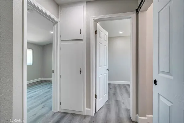 a view of a hallway with wooden floor