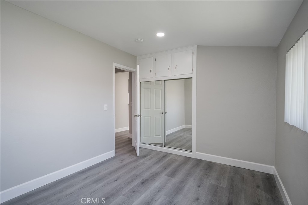 3630 Russell Street Riverside, CA 92501 - Photo 9 of 18 wooden floor in an empty room with a window