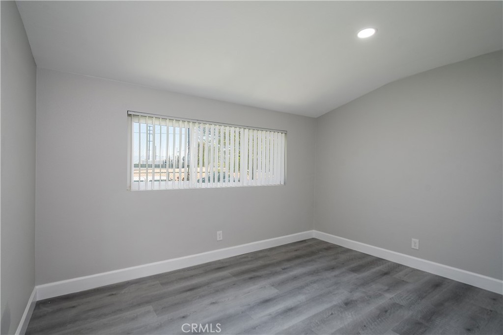 3630 Russell Street Riverside, CA 92501 - Photo 10 of 18 an empty room with wooden floor and windows
