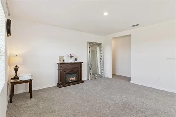 a view of empty room with a fireplace