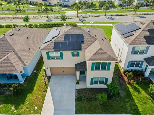 an aerial view of a house with a yard basket ball court and outdoor seating