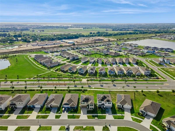 an aerial view of a house with a yard