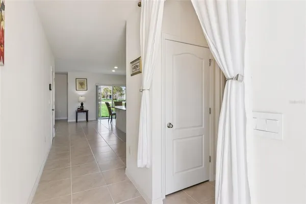 a view of a hallway with white walls and stairs