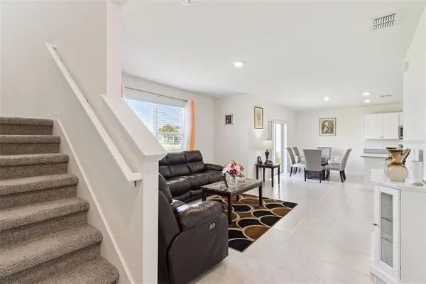 a living room with furniture and a chandelier