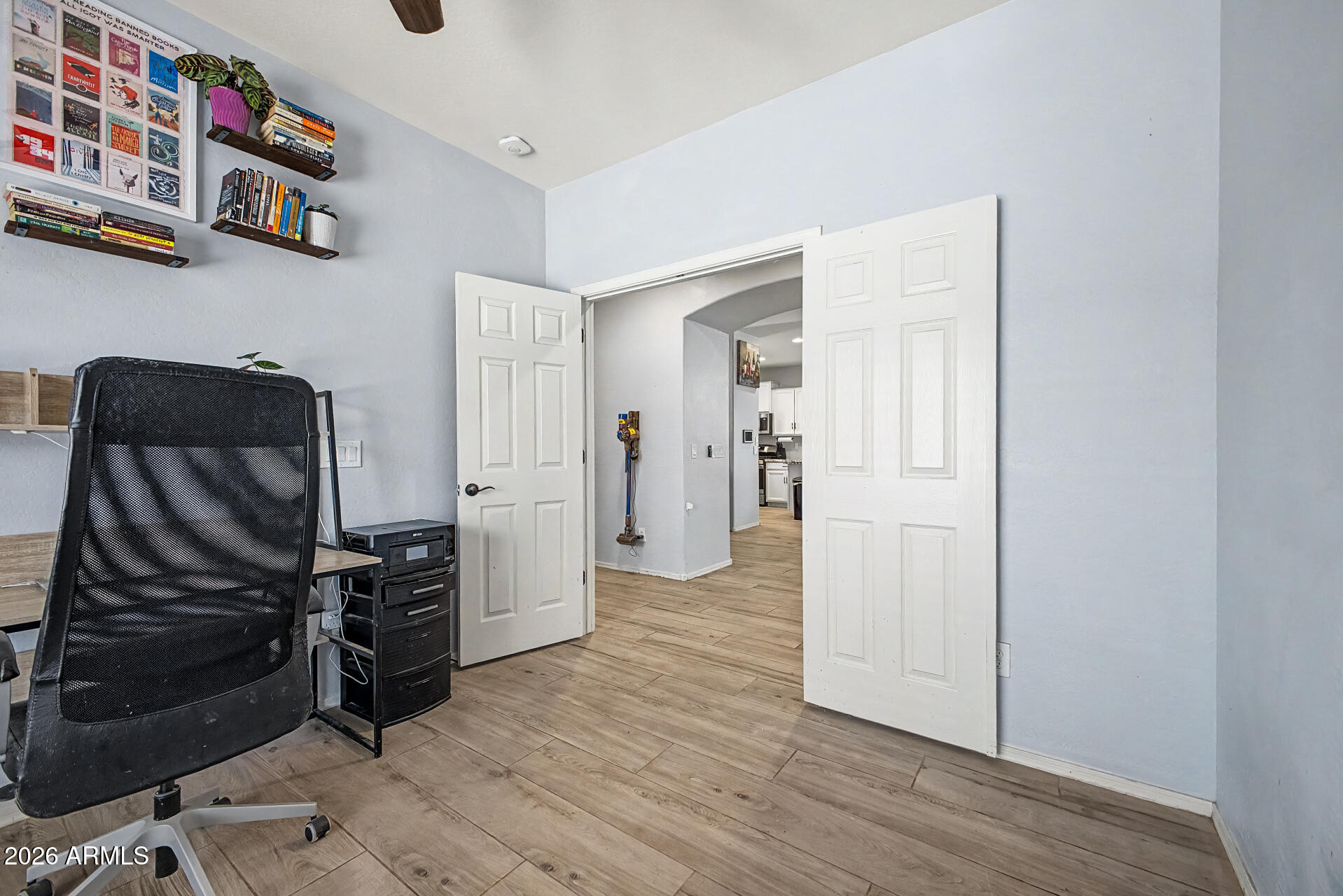16719 West Rowel Road Surprise, AZ 85387 - Photo 20 of 28 a view of a kitchen with fridge and wooden floor