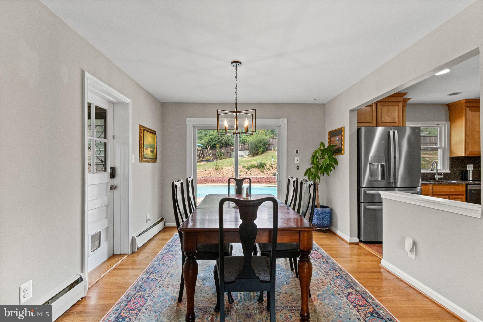 6700 Bulkley Road Lorton, VA 22079 - Photo 15 of 62 a dining room with furniture potted plants and wooden floor