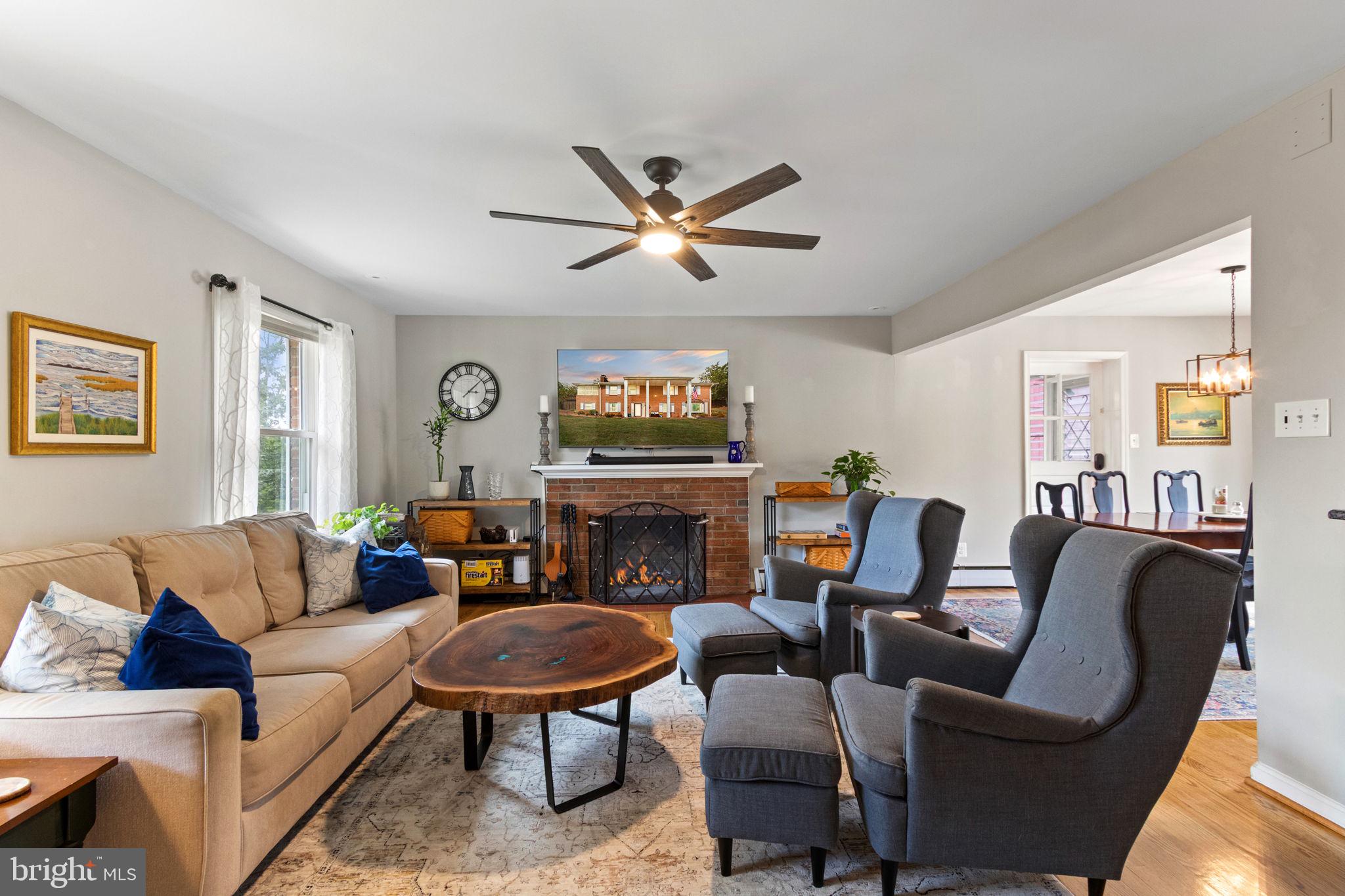 6700 Bulkley Road Lorton, VA 22079 - Photo 19 of 62 a living room with furniture a fireplace and a flat screen tv