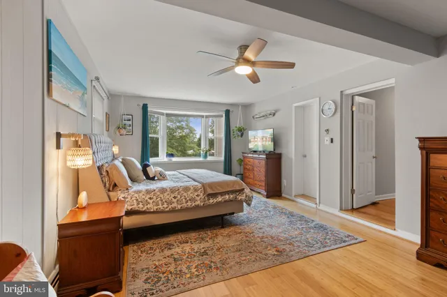 a bedroom with a bed and a lamp with window