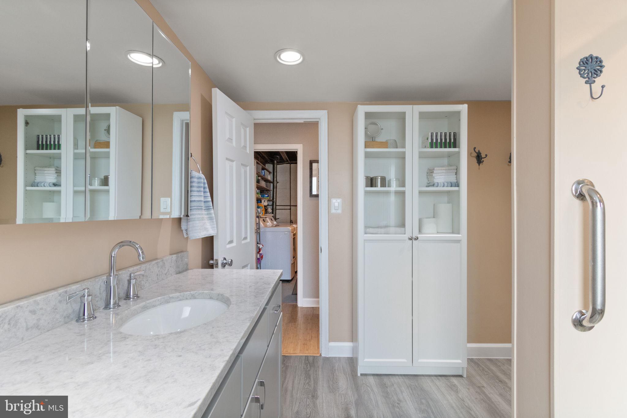 6700 Bulkley Road Lorton, VA 22079 - Photo 29 of 62 a bathroom with a granite countertop sink a mirror and shower