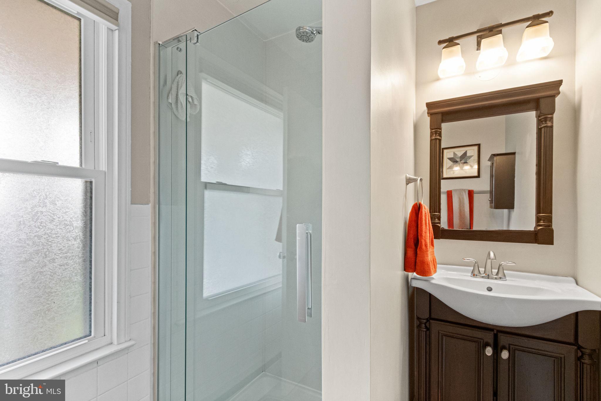 6700 Bulkley Road Lorton, VA 22079 - Photo 42 of 62 a bathroom with a sink and a mirror