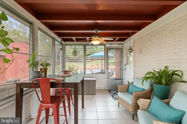 a view of a house with swimming pool and sitting area