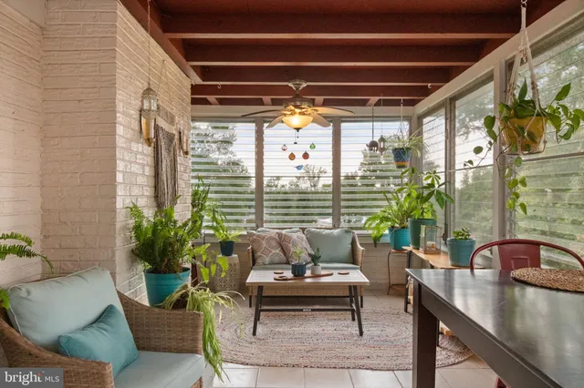 a view of backyard with potted plants and wooden fence