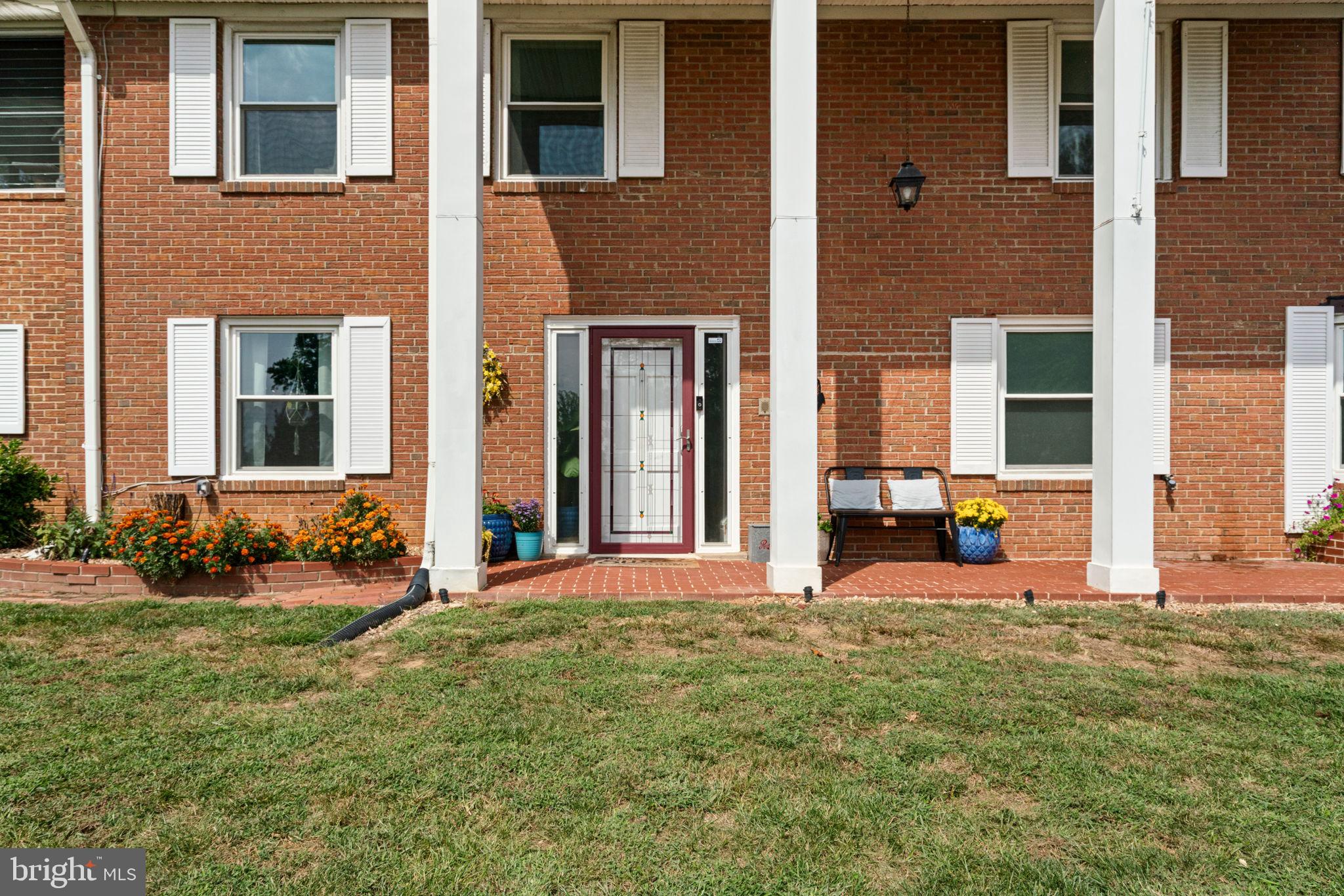 6700 Bulkley Road Lorton, VA 22079 - Photo 5 of 62 a view of a brick house with many windows and yard