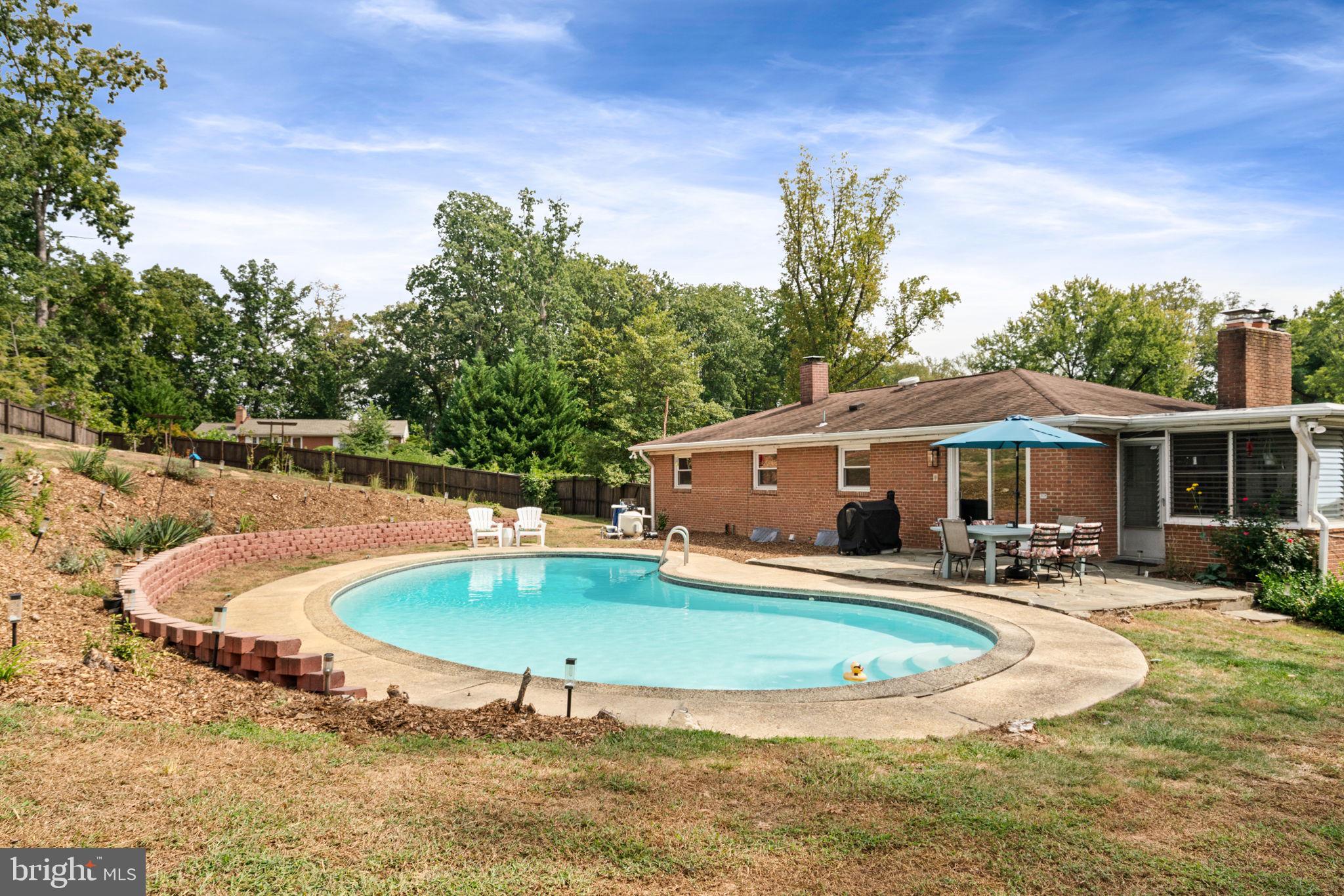 6700 Bulkley Road Lorton, VA 22079 - Photo 54 of 62 a view of a house with swimming pool and sitting area