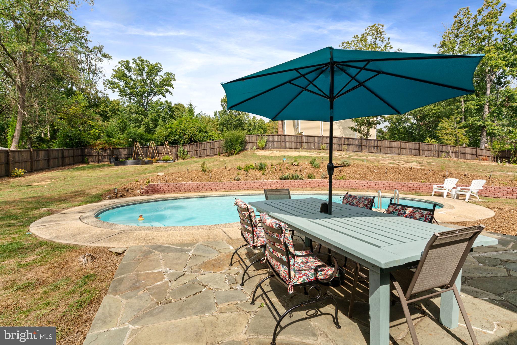 6700 Bulkley Road Lorton, VA 22079 - Photo 55 of 62 an outdoor space with furniture and umbrella