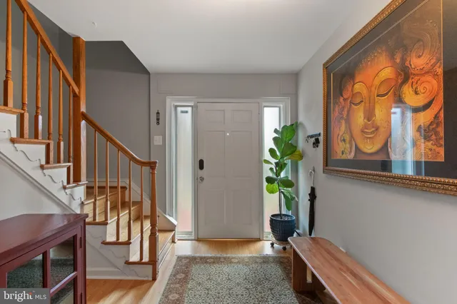 a view of a livingroom with furniture hardwood floor and windows