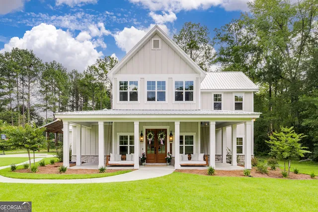 a front view of a house with a yard table and chairs