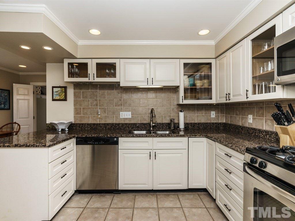 2807 Wayland Drive Raleigh, NC 27608 - Photo 11 of 24 a white kitchen with granite top and stainless steel appliances