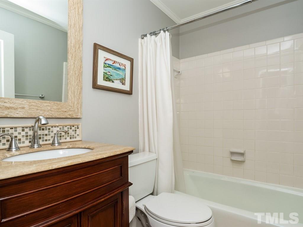 2807 Wayland Drive Raleigh, NC 27608 - Photo 15 of 24 a bathroom with a sink a toilet and shower