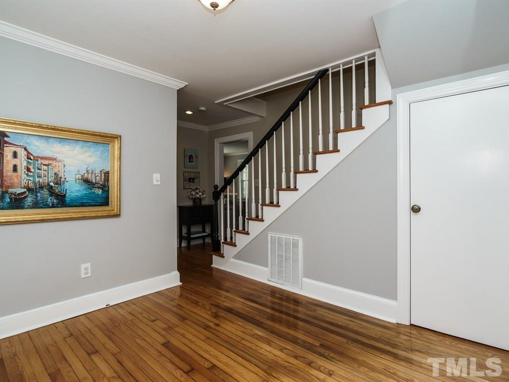 2807 Wayland Drive Raleigh, NC 27608 - Photo 9 of 24 a view of staircase with wooden floor and a rug