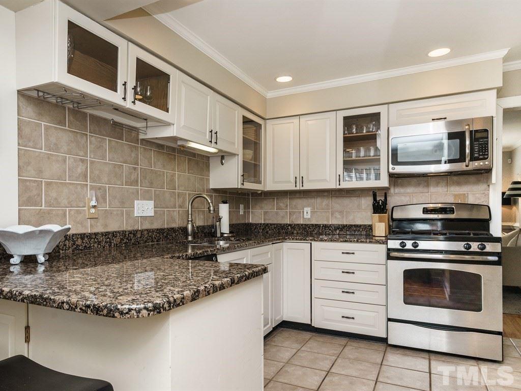 2807 Wayland Drive Raleigh, NC 27608 - Photo 10 of 24 a kitchen with stainless steel appliances granite countertop a stove and a microwave